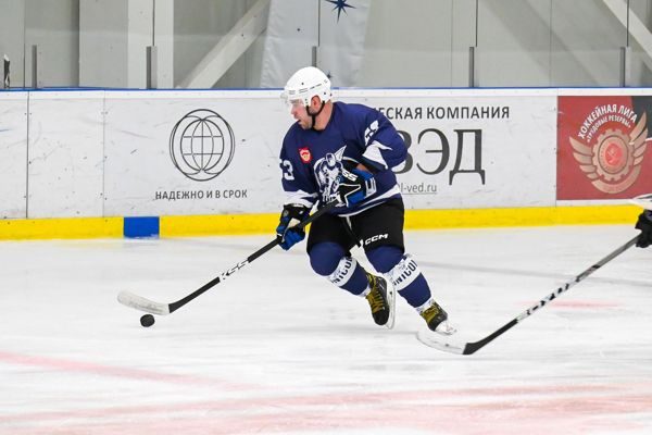 Хоккеист ХК Юником Карго с шайбой у борта